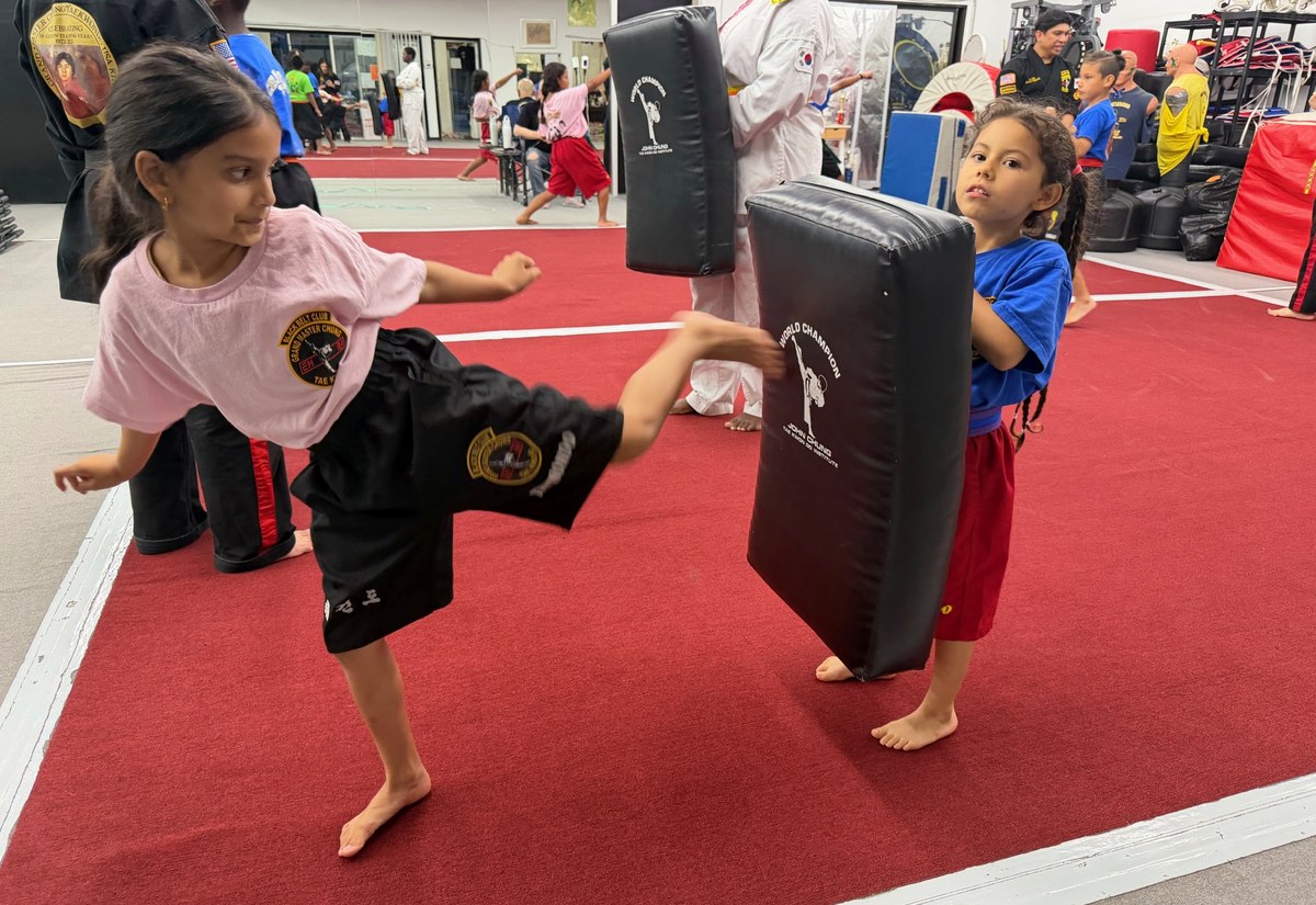 Two students practicing a partner pad drill.